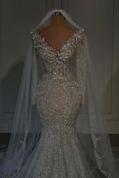 Cocosbride Close-up of sequined details and elegant sleeves on a luxury mermaid wedding dress
