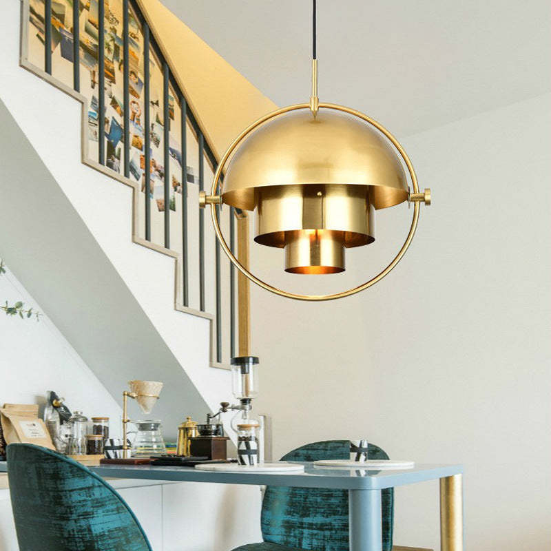 Gold modern pendant light over dining table