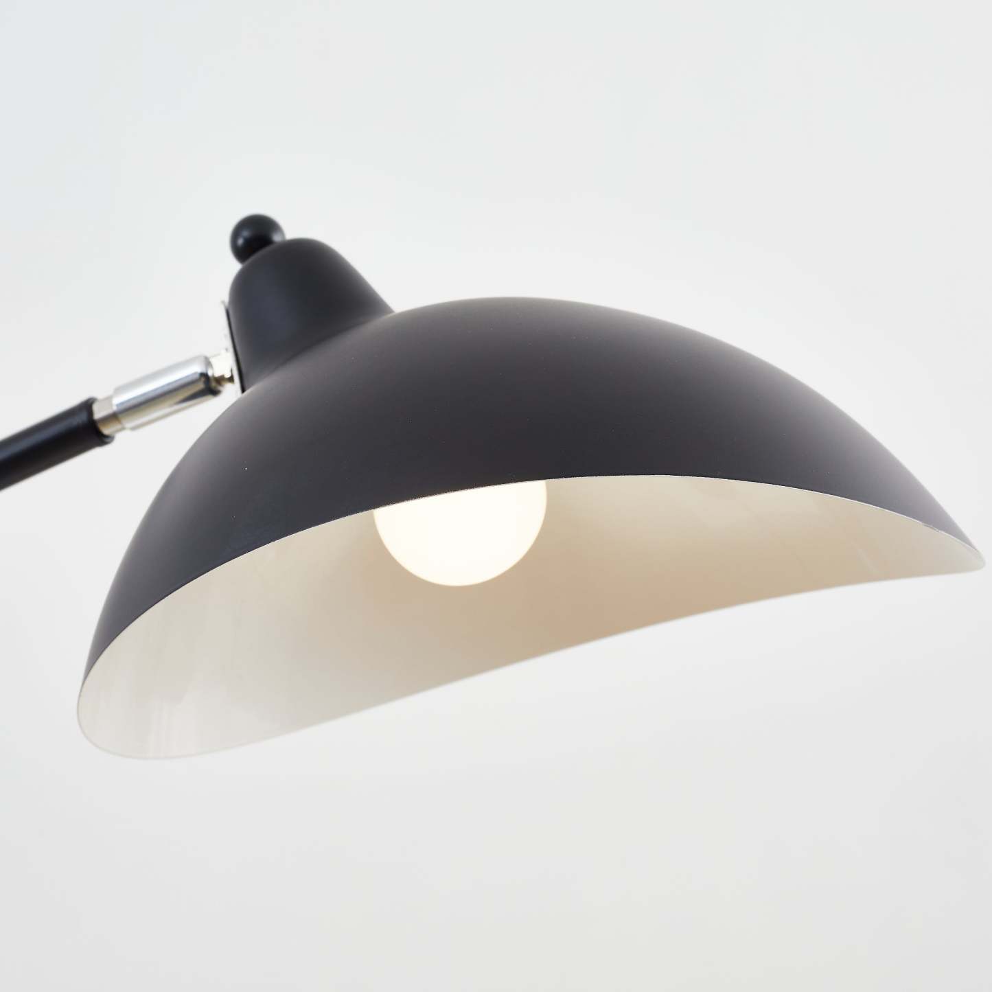 Close-up of Salgado black floor lamp with a lit bulb