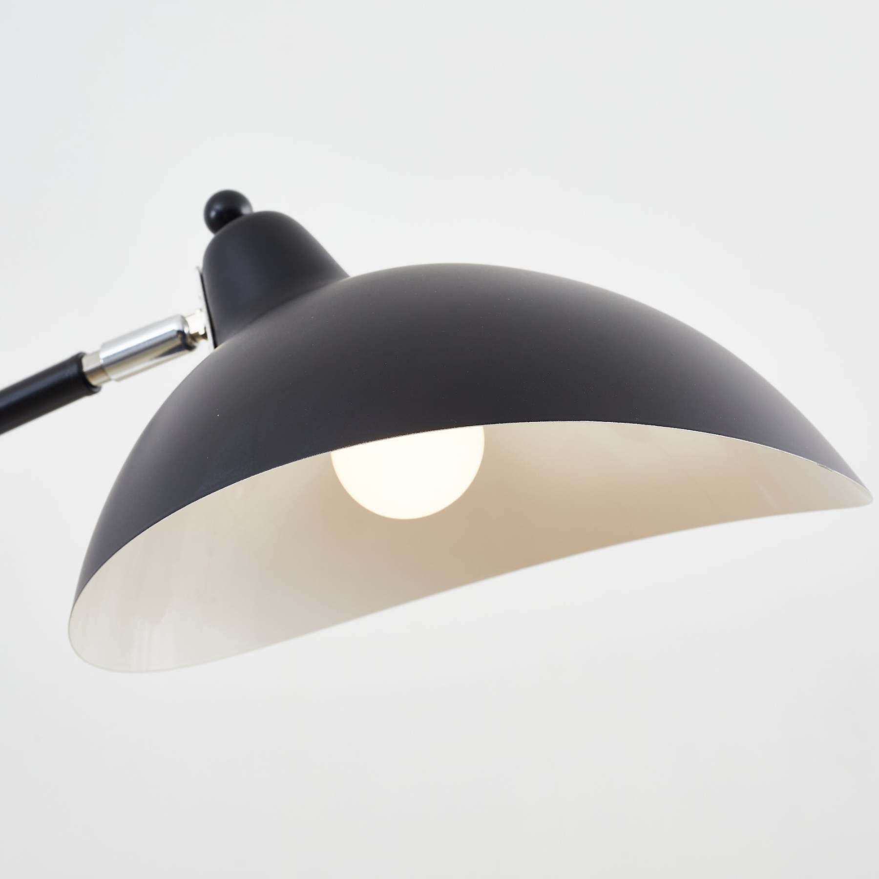 Close-up of Salgado black floor lamp with a lit bulb