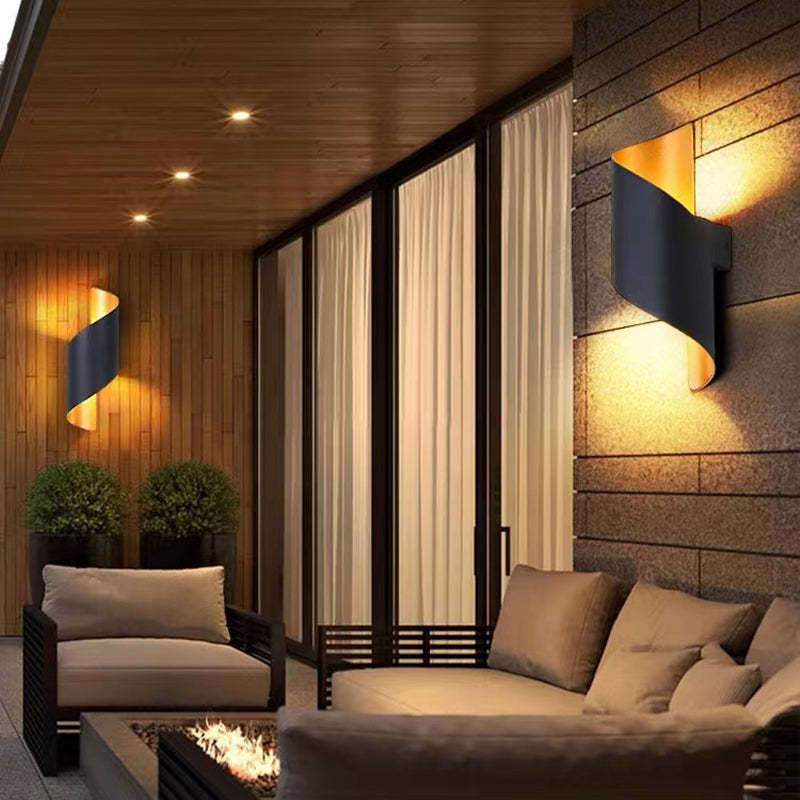 Orr conch shape metal wall light in outdoor setting.