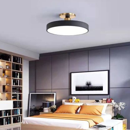 Modern bedroom featuring round flush mount ceiling light
