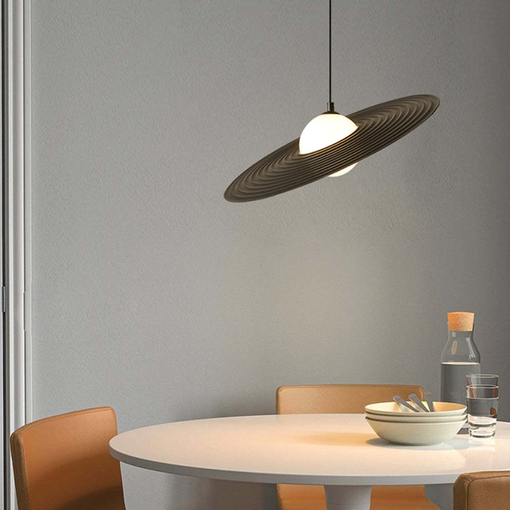 Cairns pendant light above a modern dining table. Minimalist lighting.