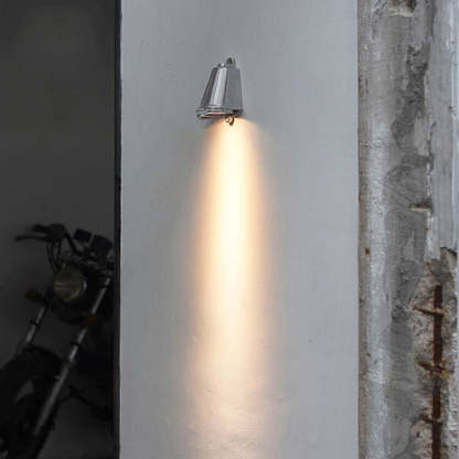 Orr metal bell wall lamp shines near motorbike