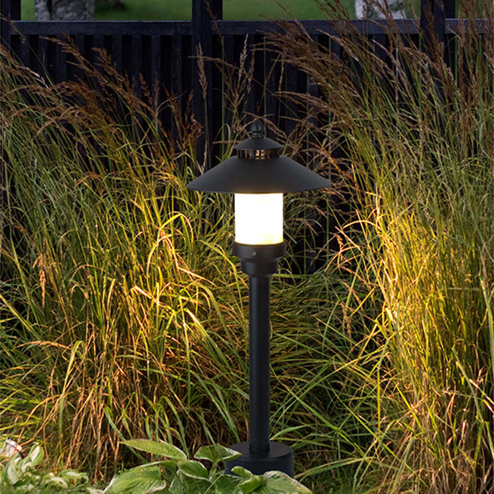 Black Carins outdoor path light in a garden setting