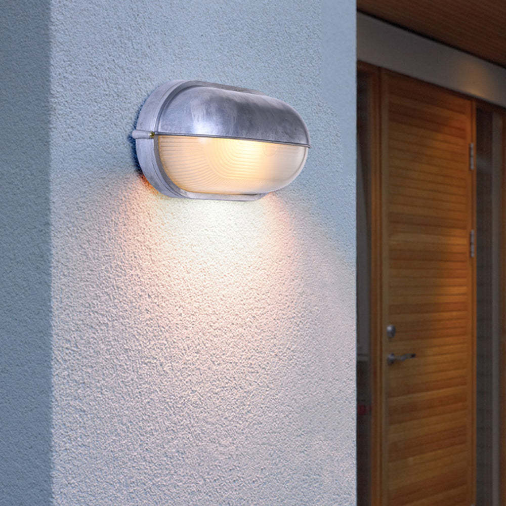 Outdoor Ellipse Wall Lamp illuminating a doorway.