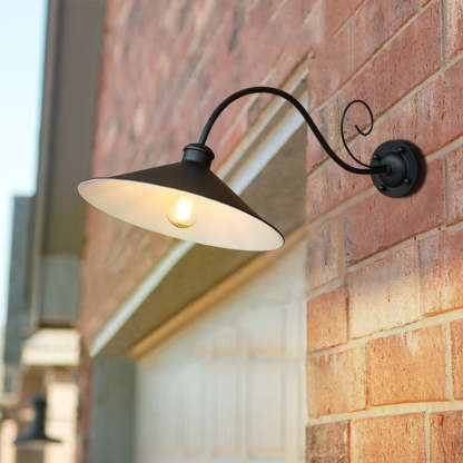Black Alessio vintage outdoor wall lamp on brick wall.