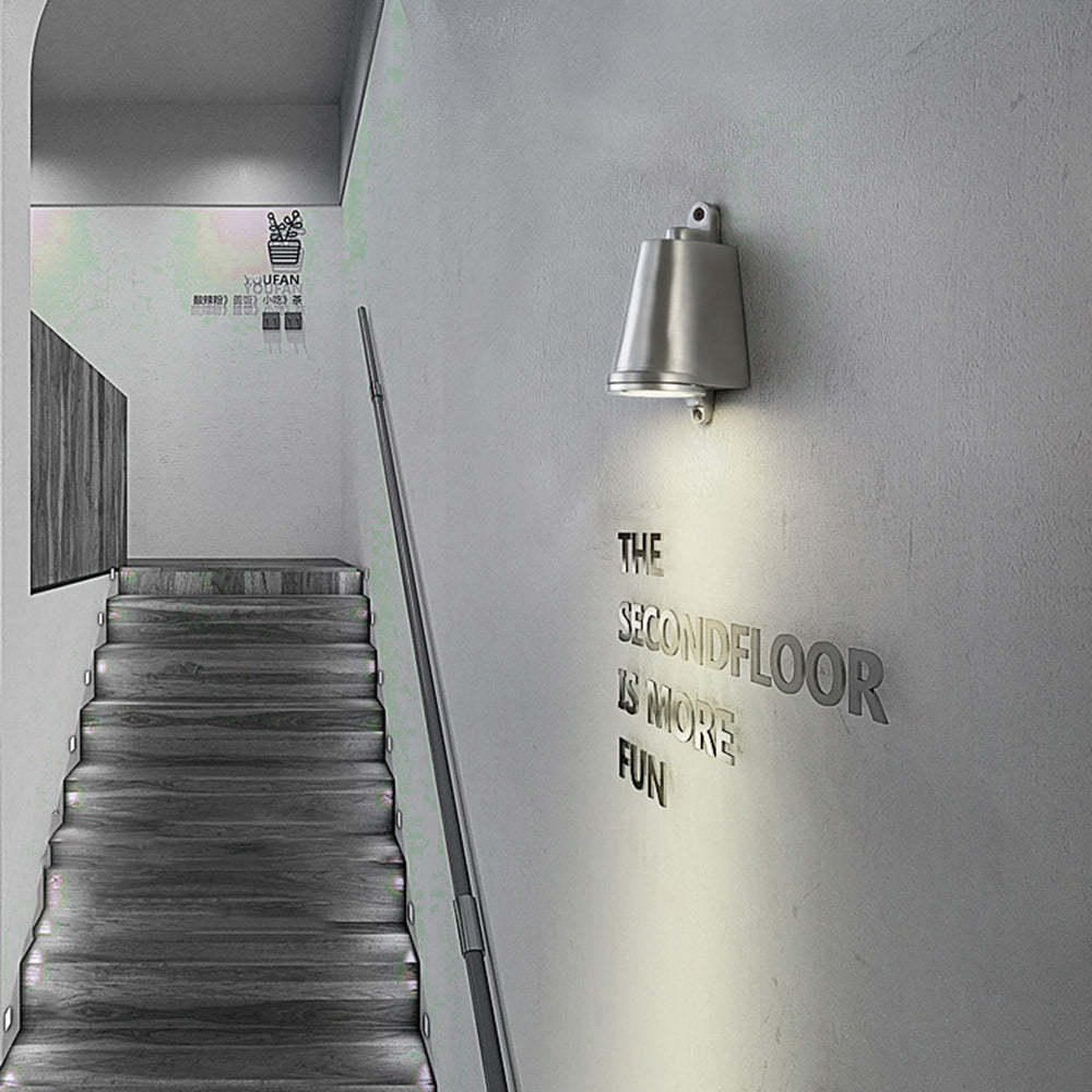 Orr industrial metal wall lamp illuminates staircase to the second floor