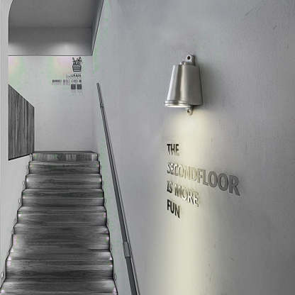 Orr industrial metal wall lamp illuminates staircase to the second floor