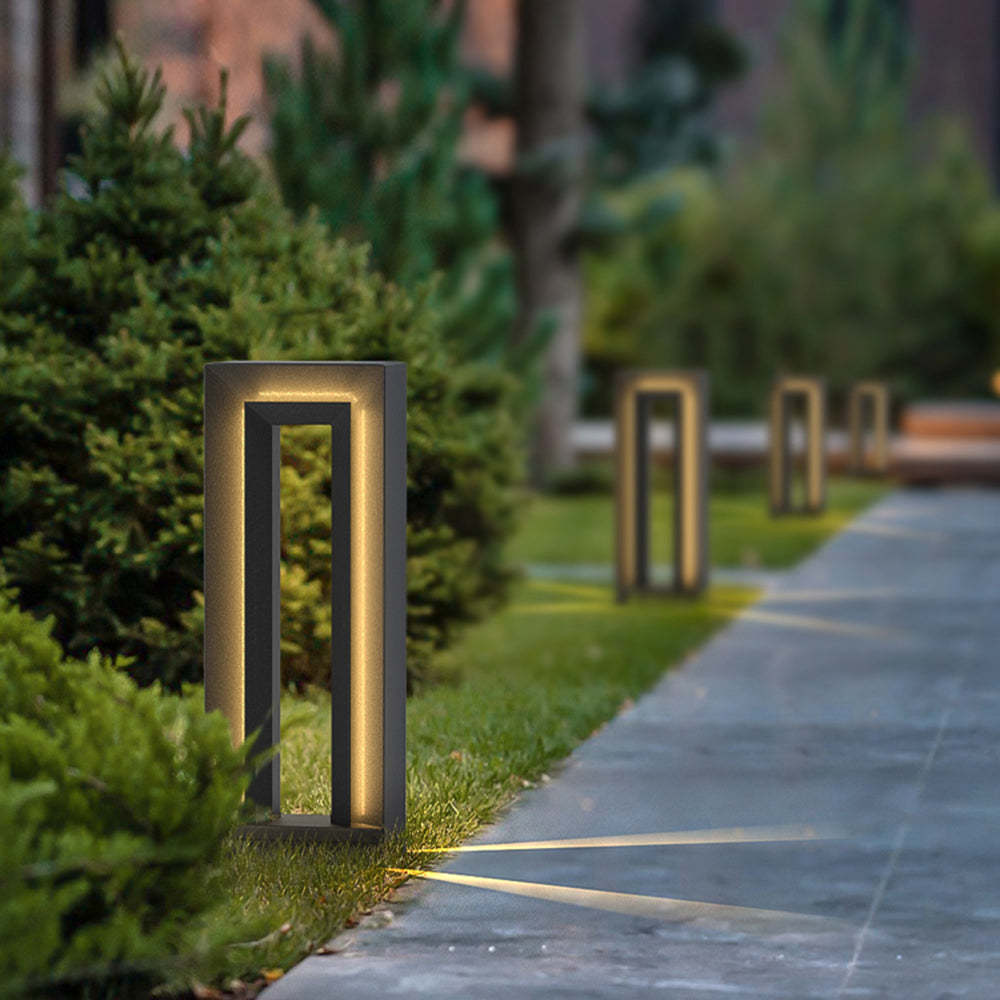 Modernist outdoor path lights illuminate garden at night