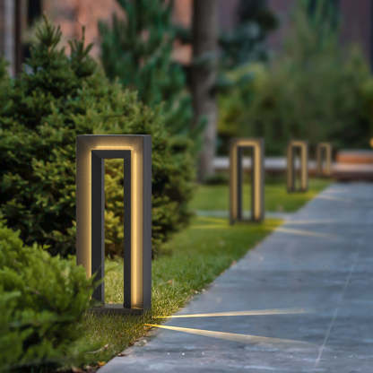 Modernist outdoor path lights illuminate garden at night