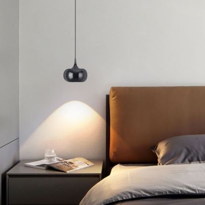 Hailie Retro Nordic pendant light illuminating bedroom with bedside table