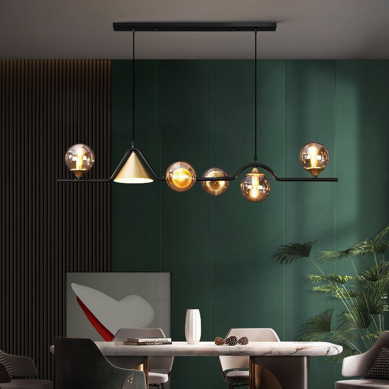 Modern glass pendant light fixture over dining table