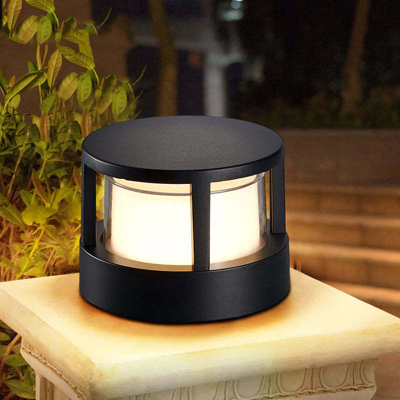Modern outdoor bollard light illuminating garden