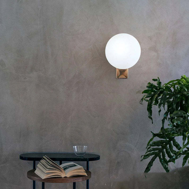 Valentina Minimalist Wall Lamp illuminating a bedroom corner