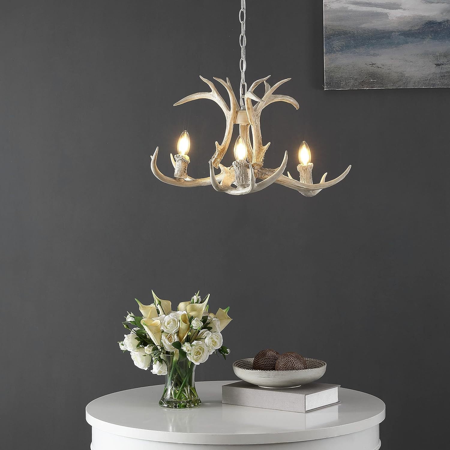 Antler-style pendant light over white table
