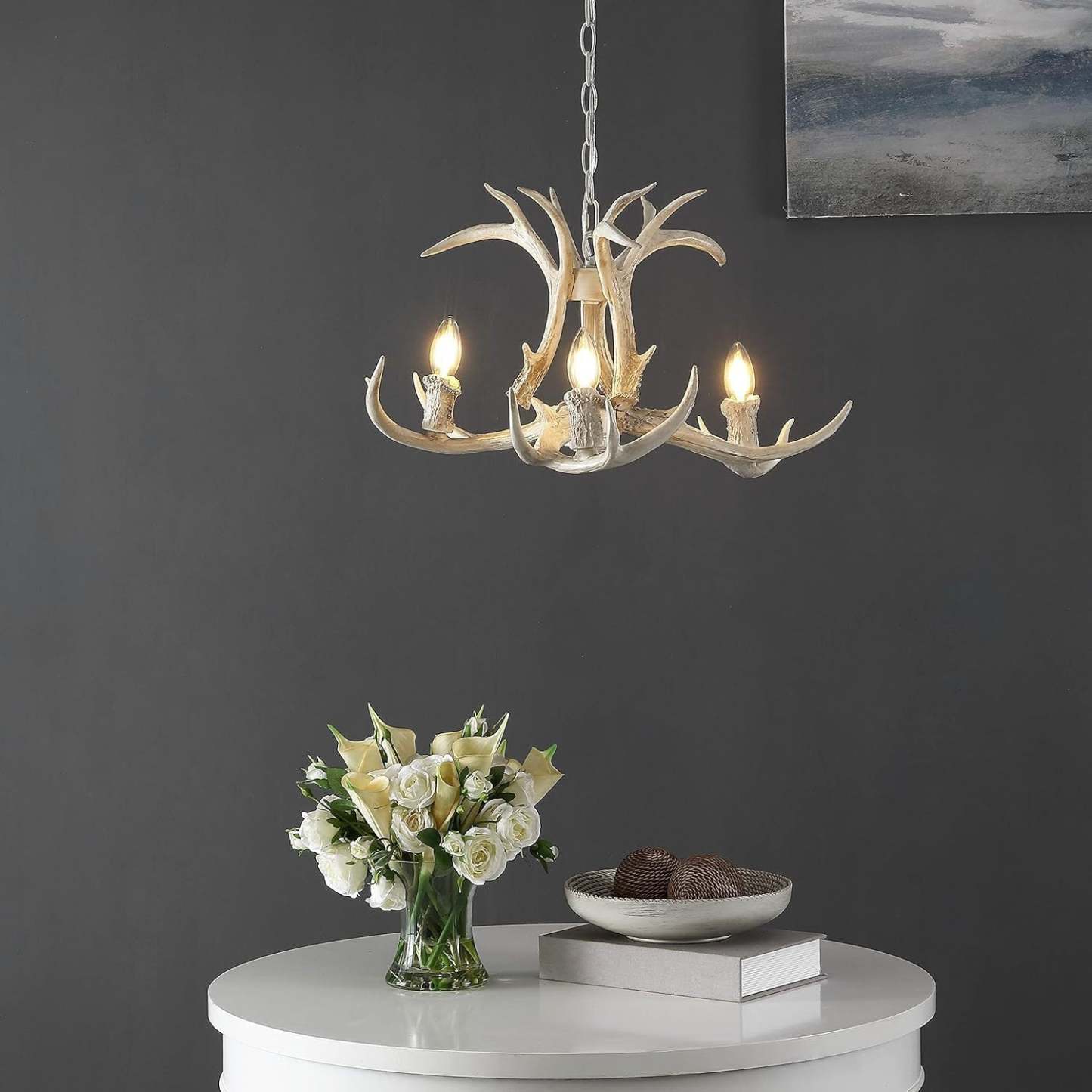 Antler-style pendant light over white table