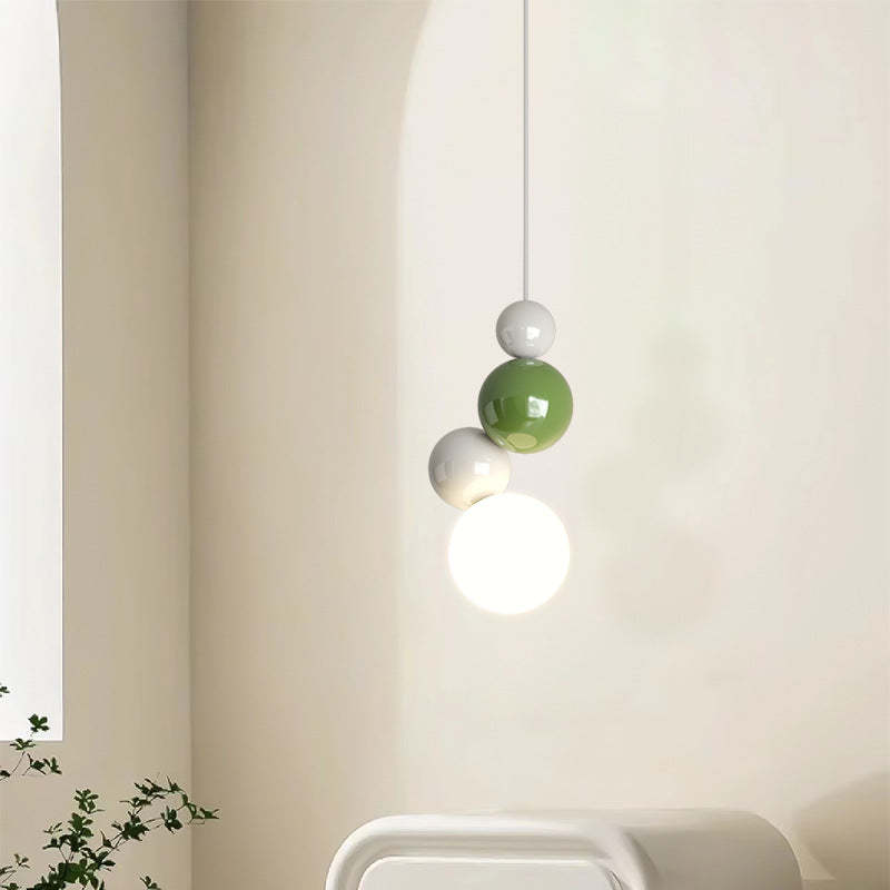 Modern pendant light with white, green, and grey orbs