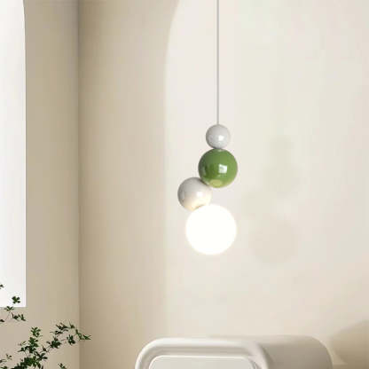 Modern pendant light with white, green, and grey orbs