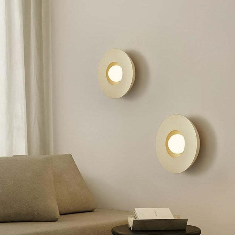 Modern, circular LED wall lamps, milky coffee color, in a living room setting