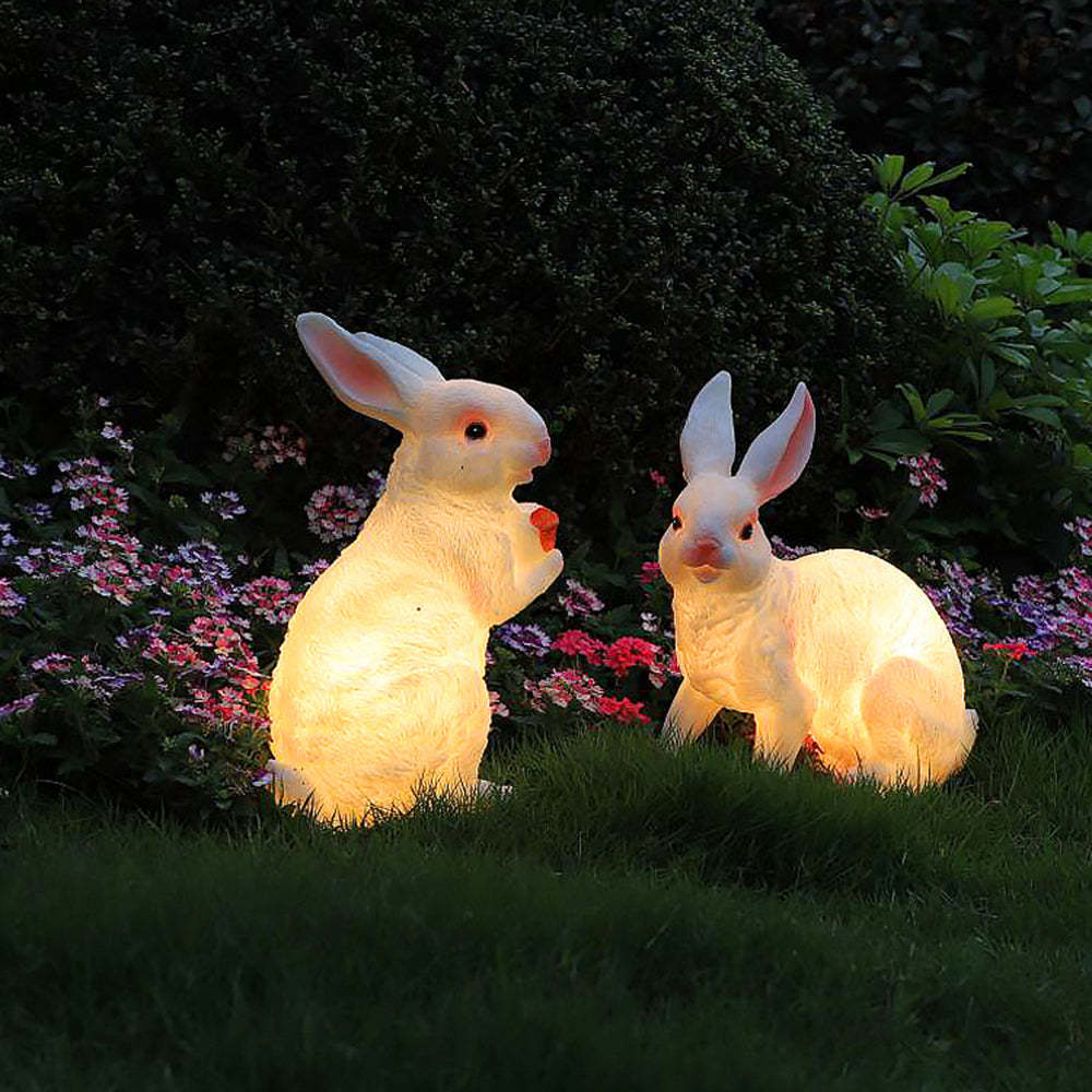 Two rabbit LED outdoor floor lamps in garden setting.