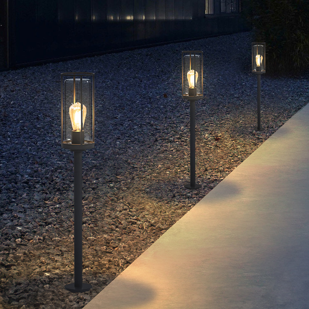 Modern outdoor pathway lighting with cylindrical metal lanterns