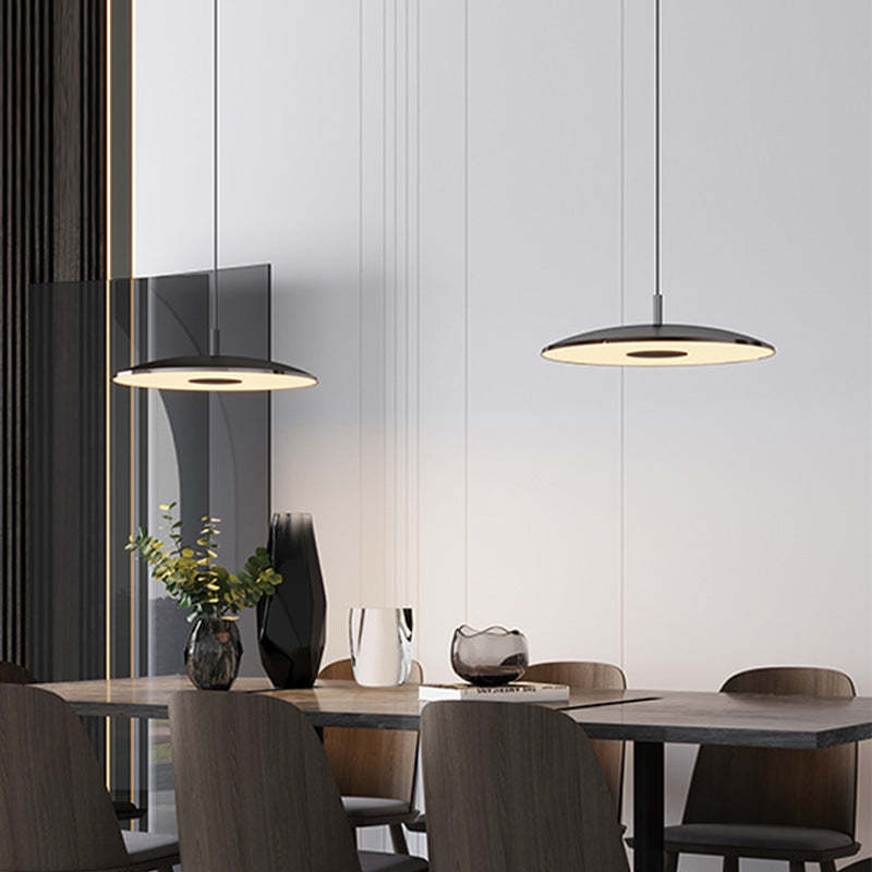 Modern Cairns pendant lights illuminating a dining room