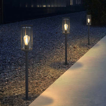 Modern outdoor pathway lighting with cylindrical metal lanterns