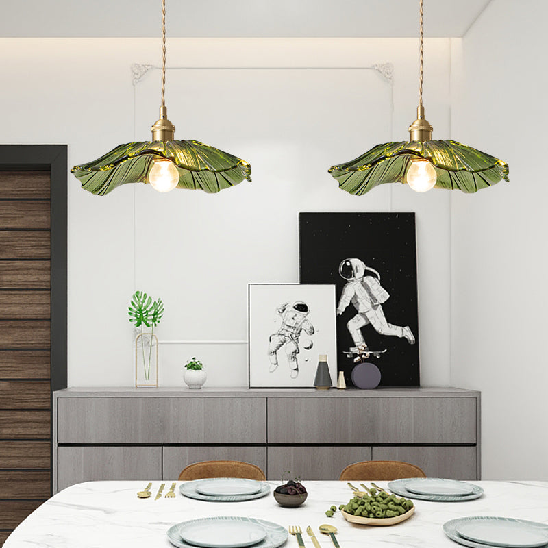 Green glass Carins flower pendant lights over dining table