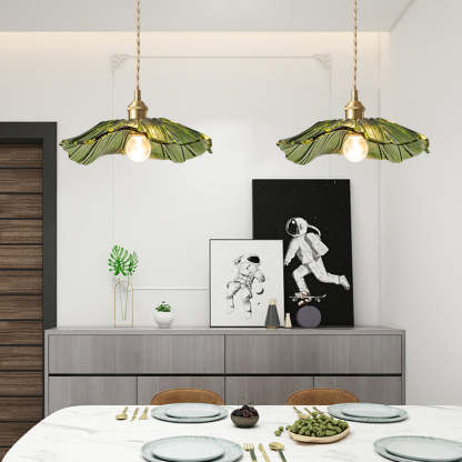 Green glass Carins flower pendant lights over dining table