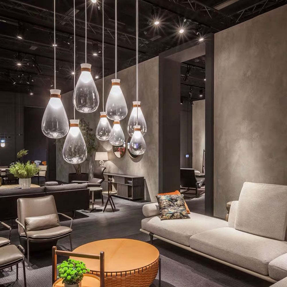 Teardrop glass pendant lights illuminate modern living room.