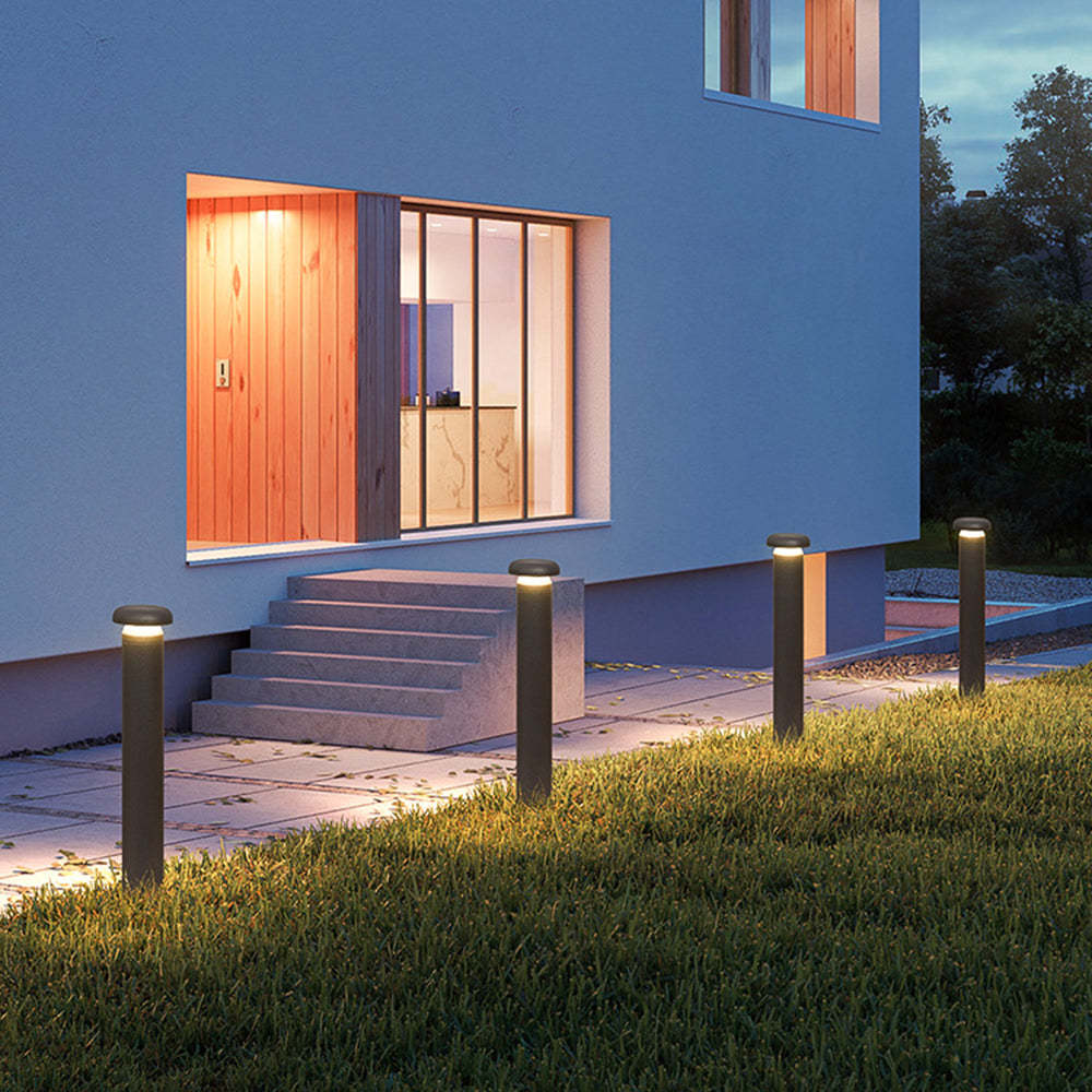 Exterior view of Pena outdoor path lights illuminating a modern home