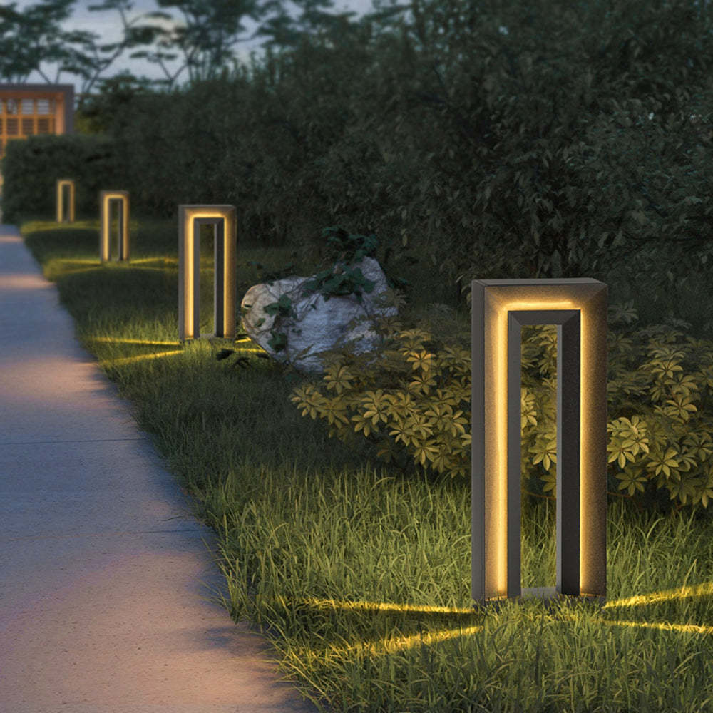 Modernist Pena outdoor path light illuminating a garden path at night