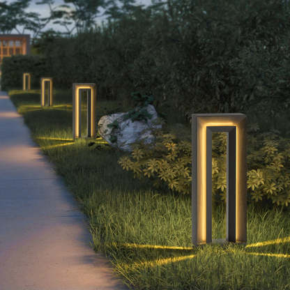Modernist Pena outdoor path light illuminating a garden path at night