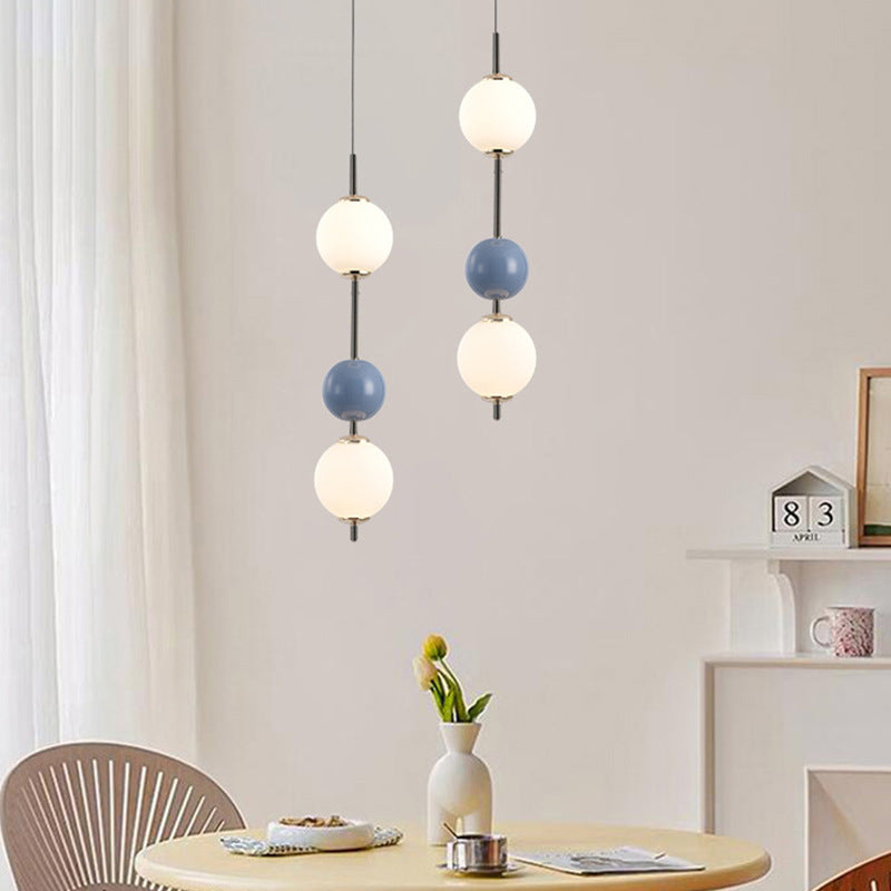 Modern pendant lights with sphere design, in a dining room.