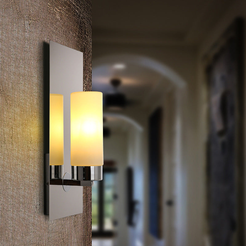 Quinn wall lamp in corridor, modern metal and glass lighting fixture