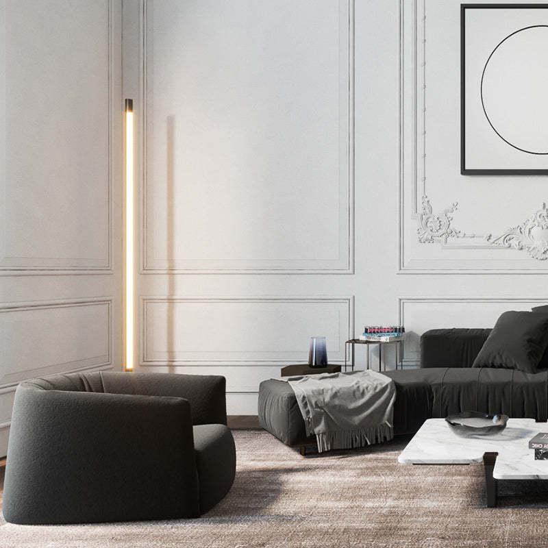 Edge minimalist floor lamp illuminating a modern living room