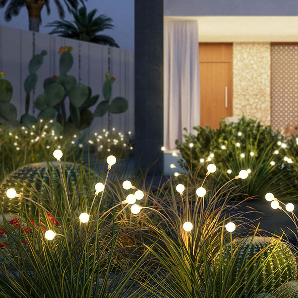 Orr Firefly outdoor lights illuminating a garden at night