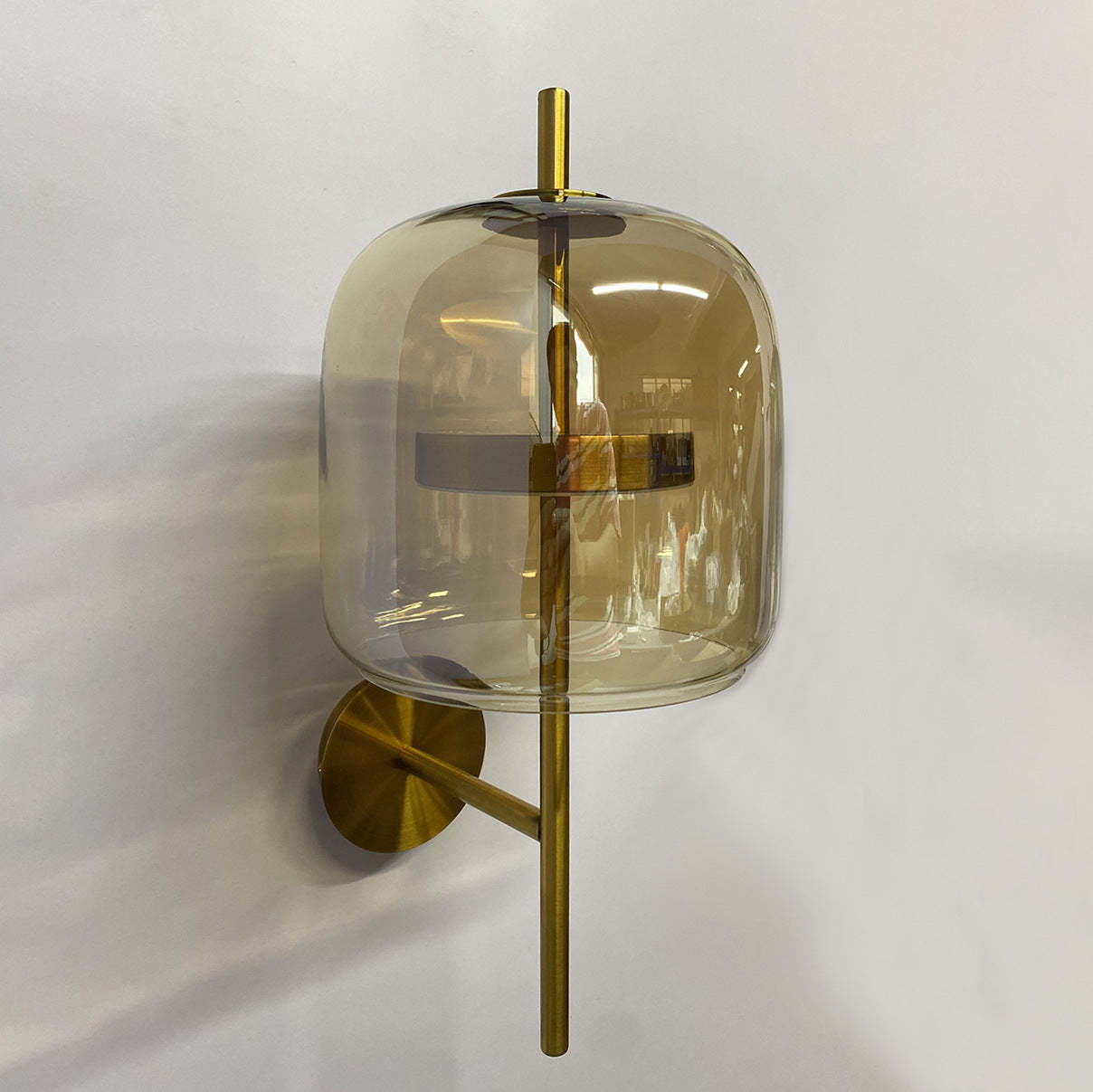 Modern Quinn wall lamp with amber glass shade and gold accents