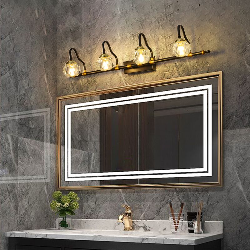 Crystal globe vanity wall lamp above bathroom mirror