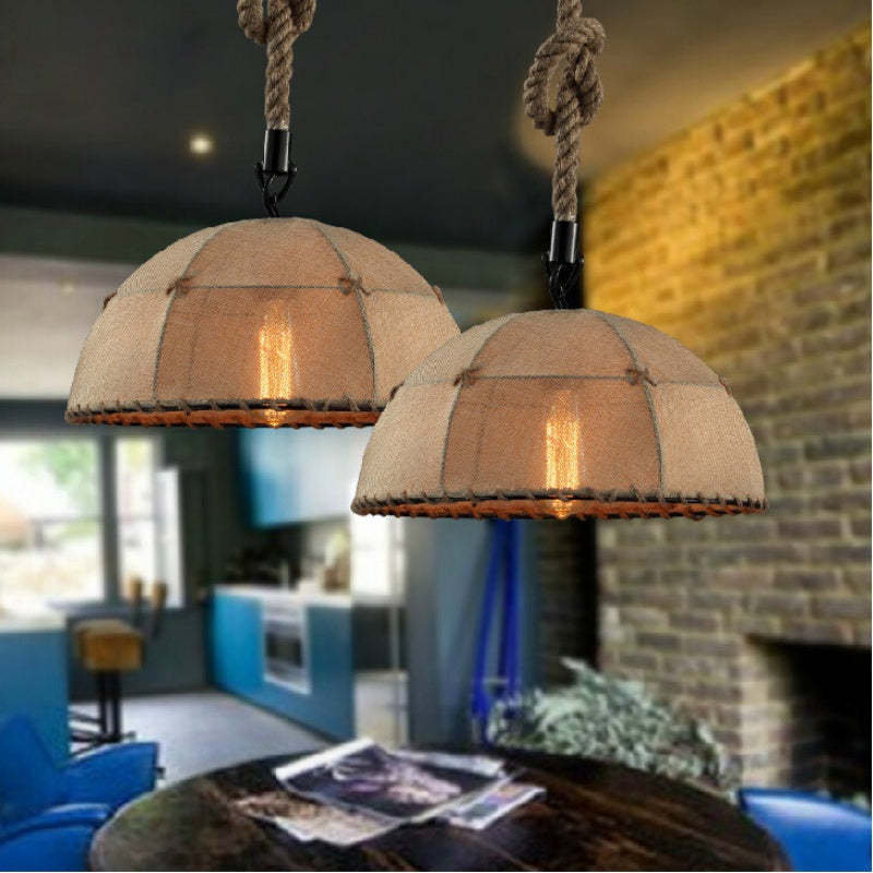 Industrial pendant light with rope detail, illuminating a room.