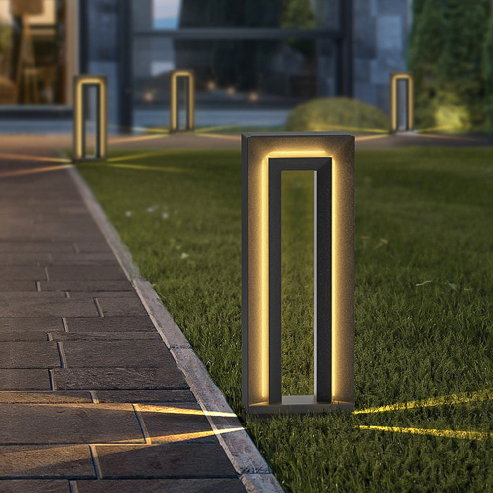 Modern Pena outdoor path light illuminating a garden at night