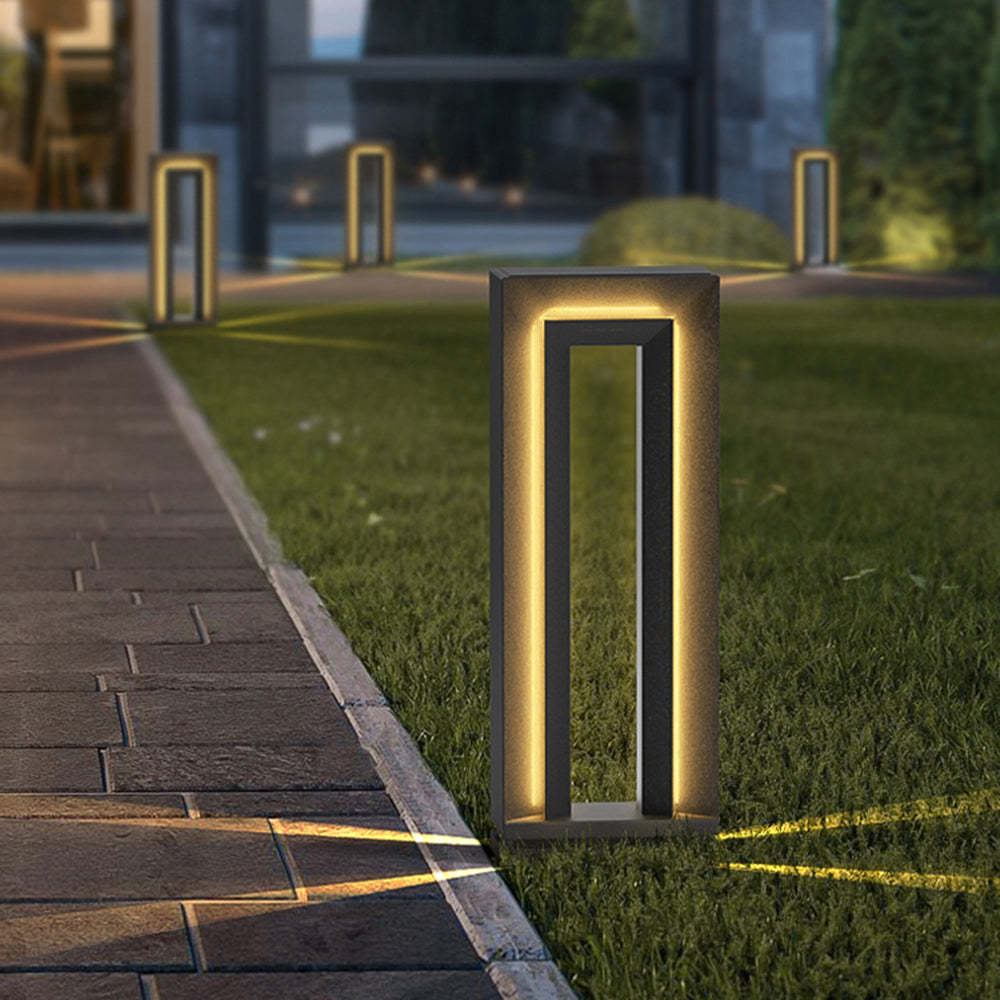 Modern Pena outdoor path light illuminating a garden at night