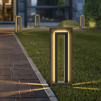 Modern Pena outdoor path light illuminating a garden at night