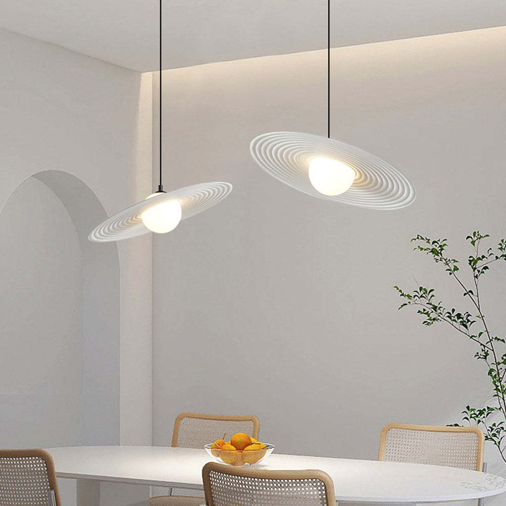 Cairns minimalist pendant light above dining table setting.