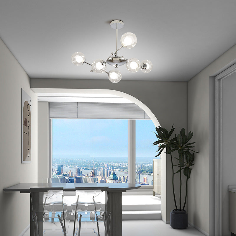 Modern chandelier above dining table with city view