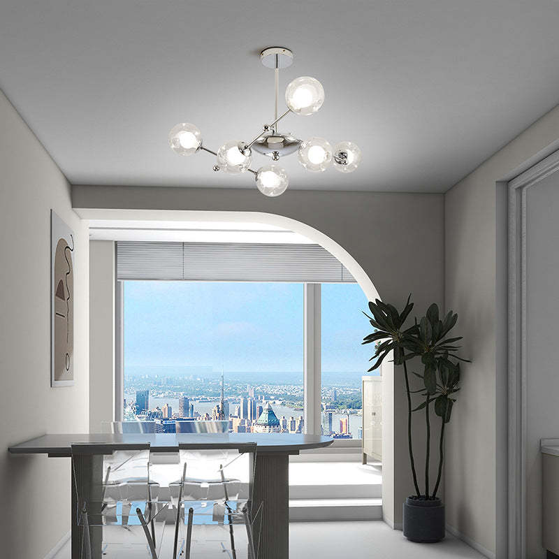 Modern chandelier above dining table with city view