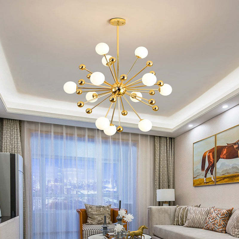 Alessio LED Chandelier. Modern gold lighting fixture in living room.