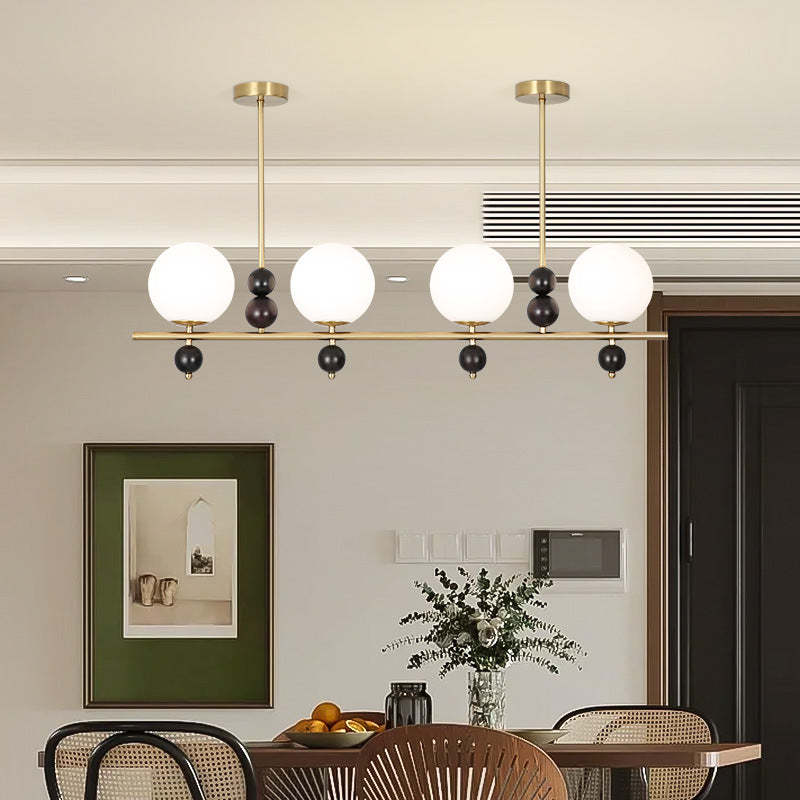 Gold Valentina pendant light over dining table