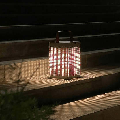 Orr outdoor floor lamp on stairs casting lattice shadows.